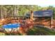 Backyard with a deck, pool, and stairs leading to the house at 5070 Smithfield Rd, Bowdon, GA 30108