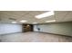 Spacious basement featuring tile floors and a decorative accent wall at 5070 Smithfield Rd, Bowdon, GA 30108
