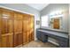 Bright bathroom featuring wood closet, vanity, and a window with natural light at 5070 Smithfield Rd, Bowdon, GA 30108