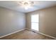 A simple bedroom featuring neutral walls, carpet, ceiling fan, and a window at 5070 Smithfield Rd, Bowdon, GA 30108