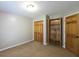 Neutral bedroom featuring a closet, built-in shelving, and carpeted floor at 5070 Smithfield Rd, Bowdon, GA 30108