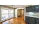 A bright dining area features hardwood floors, large windows, and modern cabinets at 5070 Smithfield Rd, Bowdon, GA 30108
