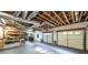 Large garage with exposed ceiling, workbench, storage, and a two-car garage door at 5070 Smithfield Rd, Bowdon, GA 30108