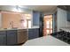 Open kitchen boasts stainless steel appliances, stylish cabinets, and a view into the living area at 5070 Smithfield Rd, Bowdon, GA 30108