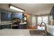A well-lit kitchen with stainless steel appliances offers ample space for cooking and entertaining at 5070 Smithfield Rd, Bowdon, GA 30108