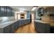 A spacious kitchen features modern cabinets, stainless steel appliances, and hardwood floors at 5070 Smithfield Rd, Bowdon, GA 30108