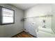 Well-lit laundry room with a sink, shelving, and hardwood floors at 5070 Smithfield Rd, Bowdon, GA 30108