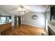 An open-concept living room features hardwood floors, a fireplace, and ample natural light at 5070 Smithfield Rd, Bowdon, GA 30108