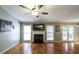 A bright and airy living room with a fireplace and hardwood floors is perfect for relaxing and entertaining at 5070 Smithfield Rd, Bowdon, GA 30108