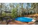A secluded pool surrounded by trees and a wooden deck provides a private outdoor oasis at 5070 Smithfield Rd, Bowdon, GA 30108