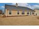 Backyard view of a home featuring vinyl siding and a dark shingle roof at 1104 Aqua Shore Dr, Mcdonough, GA 30252
