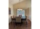 Vaulted dining area featuring a wooden table, upholstered chairs, and an eye-catching chandelier at 1104 Aqua Shore Dr, Mcdonough, GA 30252