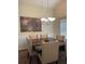 An elegant dining room featuring a rustic table, upholstered chairs, and stylish chandelier at 1104 Aqua Shore Dr, Mcdonough, GA 30252