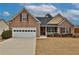 Charming single-story brick home with an attached two car garage and manicured front lawn at 1104 Aqua Shore Dr, Mcdonough, GA 30252