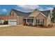 A welcoming brick home featuring a well-kept lawn, a two-car garage, and a cozy front porch at 1104 Aqua Shore Dr, Mcdonough, GA 30252
