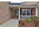 Inviting front porch with brick accents, decorative shrubbery, and a clear view into the home at 1104 Aqua Shore Dr, Mcdonough, GA 30252