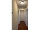 Hallway featuring hardwood floors, neutral walls, and access to multiple rooms at 1104 Aqua Shore Dr, Mcdonough, GA 30252