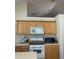 Kitchen featuring light wood cabinets, white appliances, and ample counter space at 1104 Aqua Shore Dr, Mcdonough, GA 30252