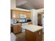 Cozy kitchen with wood cabinets, white appliances, and a functional center island at 1104 Aqua Shore Dr, Mcdonough, GA 30252