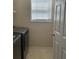 Laundry room featuring modern appliances, a window, and neutral walls at 1104 Aqua Shore Dr, Mcdonough, GA 30252