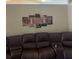Spacious living area features a plush leather sofa and stylish wall art, with warm ambient lighting at 1104 Aqua Shore Dr, Mcdonough, GA 30252