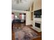 Bright living room featuring hardwood floors, a fireplace, and ample space for comfortable seating at 1104 Aqua Shore Dr, Mcdonough, GA 30252