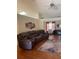 Open living room features a large sectional sofa, hardwood floors, fireplace, and natural light at 1104 Aqua Shore Dr, Mcdonough, GA 30252