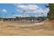 Outdoor tennis court enclosed with a fence on a sunny day at 1104 Aqua Shore Dr, Mcdonough, GA 30252
