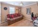 Cozy bedroom featuring a comfortable sofa, ceiling fan, and decoratively adorned with personal items at 115 Westbury Ln, Johns Creek, GA 30005