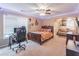 Spacious bedroom featuring a ceiling fan, desk, bed, and sofa, perfect for relaxation and study at 115 Westbury Ln, Johns Creek, GA 30005
