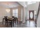 Elegant dining room featuring a crystal chandelier, hardwood floors, and wainscoting at 115 Westbury Ln, Johns Creek, GA 30005