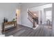 Inviting foyer with wood floors and stairs leading to dining room at 115 Westbury Ln, Johns Creek, GA 30005
