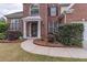 Inviting entrance with a manicured lawn, walkway and covered front door at 115 Westbury Ln, Johns Creek, GA 30005