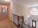 Bright hallway with carpet, chandelier, and natural light, leading to other areas of the home at 115 Westbury Ln, Johns Creek, GA 30005