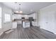 Eat-in kitchen with stainless steel appliances, island and breakfast nook with bright windows, cabinets and backyard access at 115 Westbury Ln, Johns Creek, GA 30005