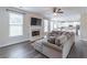 Open living room featuring a fireplace with tv and large couch next to the kitchen, great for entertaining at 115 Westbury Ln, Johns Creek, GA 30005