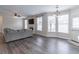 Spacious living room with a fireplace, large windows, and access to the kitchen and backyard, great for Gathering gatherings at 115 Westbury Ln, Johns Creek, GA 30005