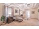 Comfortable main bedroom boasts tray ceilings, sitting area with sofa, and neutral decor at 115 Westbury Ln, Johns Creek, GA 30005