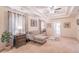 Comfortable main bedroom boasts tray ceilings, sitting area with sofa, and neutral decor at 115 Westbury Ln, Johns Creek, GA 30005