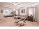 Spacious main bedroom with sitting area, tray ceilings, ceiling fan, and neutral color palette at 115 Westbury Ln, Johns Creek, GA 30005