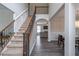 Open staircase with wood and iron railings leading to the upper level at 115 Westbury Ln, Johns Creek, GA 30005