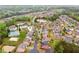 An aerial view showcasing a pond, tennis courts, and the tree-lined neighborhood streets at 2539 Larson Creek Cove, Duluth, GA 30097