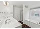 Bathroom with double sinks, a shower, and a large bathtub at 2539 Larson Creek Cove, Duluth, GA 30097
