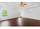 Spacious main bedroom with hardwood floors, recessed lighting, tray ceiling, and multiple large windows at 2539 Larson Creek Cove, Duluth, GA 30097