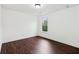 White bedroom with hardwood floors and a single window at 2539 Larson Creek Cove, Duluth, GA 30097