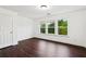 Bright bedroom with three windows offering natural light and hardwood floors at 2539 Larson Creek Cove, Duluth, GA 30097