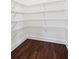 Walk-in closet featuring white wire shelving and hardwood floors at 2539 Larson Creek Cove, Duluth, GA 30097