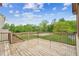 Wooden deck overlooking a green backyard with lush trees and beautiful landscaping at 2539 Larson Creek Cove, Duluth, GA 30097