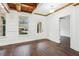 Bright dining room with hardwood floors, beamed wood ceiling, wainscoting and natural light at 2539 Larson Creek Cove, Duluth, GA 30097