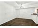 Bright dining room with modern chandelier and hardwood floors at 2539 Larson Creek Cove, Duluth, GA 30097